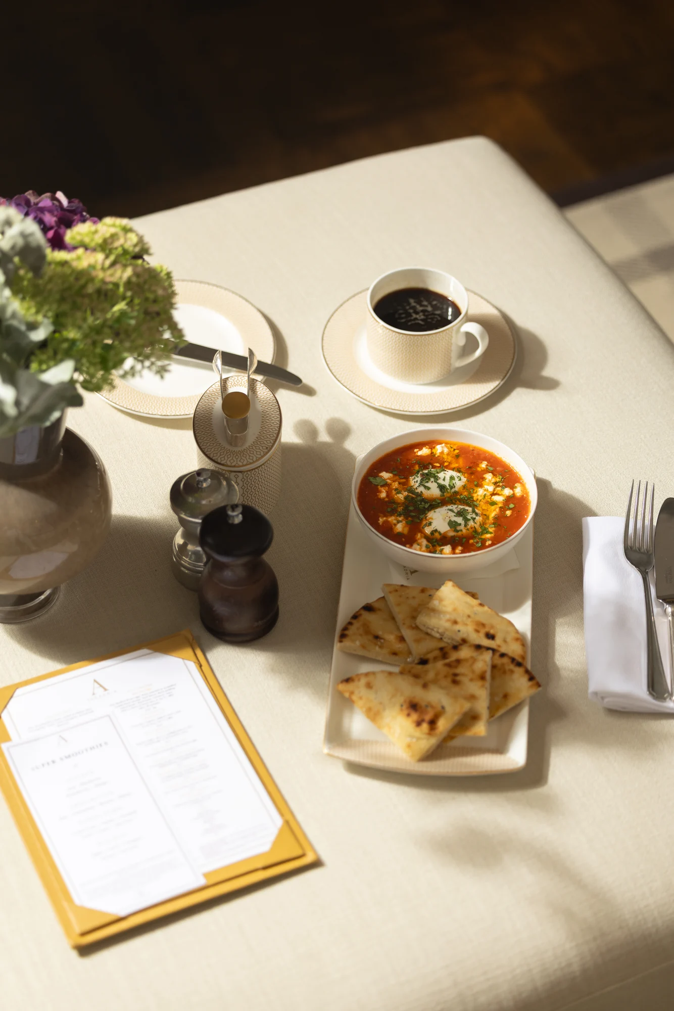 Breakfast laid out on a table in the sunlight